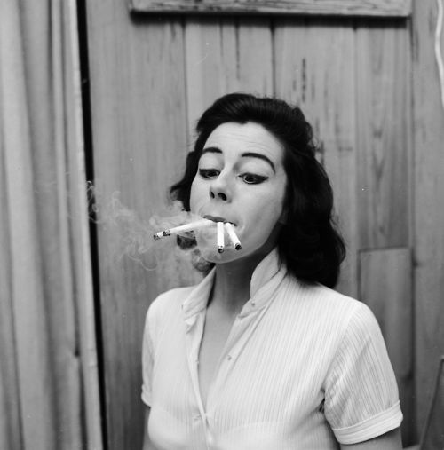 Smoking four cigarettes at once. From a series of images parodying women's lifestyle and beauty magazines.  (Photo by Jacobsen/Getty Images)